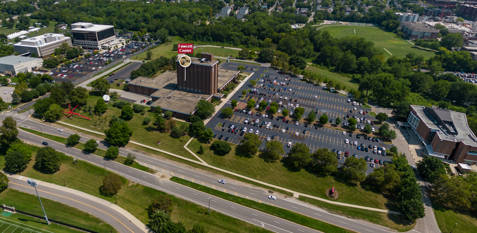 Image of the Fawcett Center and parking lot on a sunny day